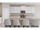 Kitchen island with granite counter and stainless steel appliances at 33700 Hamilton Hill Ln, Wesley Chapel, FL 33545