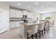 Island kitchen boasts granite countertops and bar stool seating at 33700 Hamilton Hill Ln, Wesley Chapel, FL 33545