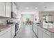 Bright kitchen featuring white cabinets, granite countertops and stainless steel appliances at 33700 Hamilton Hill Ln, Wesley Chapel, FL 33545