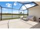 Screened lanai with patio furniture and views of the lake at 33700 Hamilton Hill Ln, Wesley Chapel, FL 33545