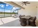 Covered lanai with outdoor table and chairs, plus a beautiful lake view at 33700 Hamilton Hill Ln, Wesley Chapel, FL 33545