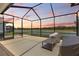 Lanai with lights and view of the lake at sunset at 33700 Hamilton Hill Ln, Wesley Chapel, FL 33545