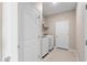 Laundry room with stacked washer and dryer, tile flooring and neutral walls at 33700 Hamilton Hill Ln, Wesley Chapel, FL 33545