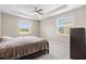 Bedroom with tray ceiling, fan, and view of backyard at 33700 Hamilton Hill Ln, Wesley Chapel, FL 33545