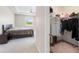 Spacious main bedroom featuring a ceiling fan, walk-in closet and a comfortable bed for relaxing at 33700 Hamilton Hill Ln, Wesley Chapel, FL 33545