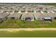 A view of a neighborhood with homes that feature a screened in patio and large backyards at 33700 Hamilton Hill Ln, Wesley Chapel, FL 33545