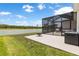 View of the screened patio and fire pit near the lake, providing a relaxing outdoor space at 33700 Hamilton Hill Ln, Wesley Chapel, FL 33545