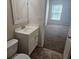 Bathroom with neutral tiles, a large vanity, and a view into the bedroom at 3455 Countryside Blvd # 33, Clearwater, FL 33761