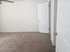 Spacious bedroom featuring neutral walls and carpet with a ceiling fan and white door at 3455 Countryside Blvd # 33, Clearwater, FL 33761
