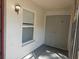 Close-up of the entryway to the home with window and storage area at 3455 Countryside Blvd # 33, Clearwater, FL 33761
