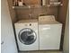Complete laundry area with modern appliances and shelving for organizing supplies at 3455 Countryside Blvd # 33, Clearwater, FL 33761