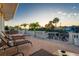 Inviting backyard area featuring lounge chairs, lawn games, and serene canal views at 3691 Center Cir, Largo, FL 33774