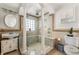 Luxurious bathroom showcases a glass-enclosed shower with bench seating and elegant fixtures at 3691 Center Cir, Largo, FL 33774