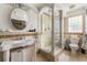 Elegant bathroom featuring a glass shower with column, stylish vanity, and tiled walls, creating a luxurious space at 3691 Center Cir, Largo, FL 33774