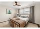 Cozy bedroom featuring a black metal bed frame, tiled floors, and a ceiling fan at 3691 Center Cir, Largo, FL 33774