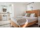 Relaxing bedroom featuring a wooden bed frame, ensuite bathroom, and neutral decor, designed for comfort and tranquility at 3691 Center Cir, Largo, FL 33774