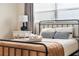 Inviting bedroom with a cozy bed, neutral decor, a side table with lamp, and natural light from a window at 3691 Center Cir, Largo, FL 33774