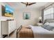 Comfortable bedroom with a full bed, ceiling fan, and dresser for additional storage at 3691 Center Cir, Largo, FL 33774