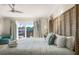 Well-lit bedroom features a bamboo bed frame, soft textures, and a ceiling fan at 3691 Center Cir, Largo, FL 33774
