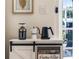 Convenient coffee bar with espresso machine, coffee grinder, tea kettle, and storage in a quaint corner setting at 3691 Center Cir, Largo, FL 33774