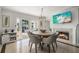 Dining area features modern fireplace, adjacent patio, and circular wooden table at 3691 Center Cir, Largo, FL 33774