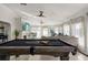Spacious game room featuring a pool table and comfortable seating for entertaining at 3691 Center Cir, Largo, FL 33774