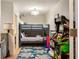 Fun room featuring a bunk bed, an arcade game, and a colorful rug, designed for entertainment and relaxation at 3691 Center Cir, Largo, FL 33774