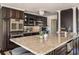 Gourmet kitchen featuring dark cabinetry, stainless steel appliances, and granite countertops at 3691 Center Cir, Largo, FL 33774