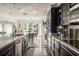 Sleek kitchen featuring custom cabinetry, a center island, and views of the dining area at 3691 Center Cir, Largo, FL 33774