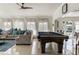 Bright living room with a pool table, comfortable seating, and decorative pillows at 3691 Center Cir, Largo, FL 33774