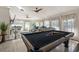 Bright living room boasts a pool table, comfortable seating, and abundant natural light at 3691 Center Cir, Largo, FL 33774