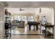 Spacious living room with a pool table, comfortable seating, and abundant natural light at 3691 Center Cir, Largo, FL 33774