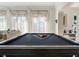 Elegant living room features a pool table and large windows for ample natural light at 3691 Center Cir, Largo, FL 33774