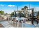 Outdoor waterfront dining area with a glass-top table, seating for six, and a private boat lift at 3691 Center Cir, Largo, FL 33774