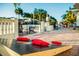 Up-close view of the outdoor cornhole game on a brick patio with beautiful landscaping in the background at 3691 Center Cir, Largo, FL 33774