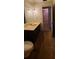 Bathroom featuring toilet, mirror, pendant lights, and open doorway to another room at 3717 Mckay Creek Dr, Largo, FL 33770
