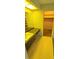 Bathroom with yellow fixtures, vanity area, and adjacent walk-in closet at 3717 Mckay Creek Dr, Largo, FL 33770