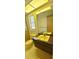 A vintage bathroom featuring a yellow sink, toilet and bath and a large mirror at 3717 Mckay Creek Dr, Largo, FL 33770
