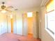 Bedroom featuring ceiling fan, windows and closet with folding doors at 3717 Mckay Creek Dr, Largo, FL 33770