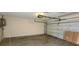 Spacious garage with roll-up door and concrete floor at 3717 Mckay Creek Dr, Largo, FL 33770