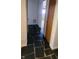 Hallway with black tiled floor leading to several rooms at 3717 Mckay Creek Dr, Largo, FL 33770