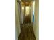 Hallway with carpeted floors featuring doorways and white walls at 3717 Mckay Creek Dr, Largo, FL 33770