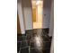 Hallway with black tiled floor leading to several rooms at 3717 Mckay Creek Dr, Largo, FL 33770