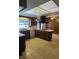 An eat-in kitchen featuring wood cabinets, a center island cooktop, and a bright decorative ceiling at 3717 Mckay Creek Dr, Largo, FL 33770
