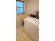 Functional laundry room features a vintage washer, dryer, and utility sink at 3717 Mckay Creek Dr, Largo, FL 33770