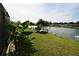 Waterfront backyard with tropical foliage and a private boat dock at 3839 Star Island Dr, Holiday, FL 34691