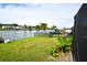 Lush backyard offers direct water access, perfect for boating and enjoying waterfront living at 3839 Star Island Dr, Holiday, FL 34691