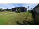 Spacious backyard featuring a home with a screened patio and well-maintained lawn at 3839 Star Island Dr, Holiday, FL 34691