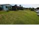 This backyard offers ample space with a green lawn, screened lanai, and clear access to the waterfront at 3839 Star Island Dr, Holiday, FL 34691