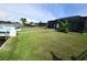 Spacious backyard with a screened lanai and lush green lawn, perfect for outdoor enjoyment at 3839 Star Island Dr, Holiday, FL 34691